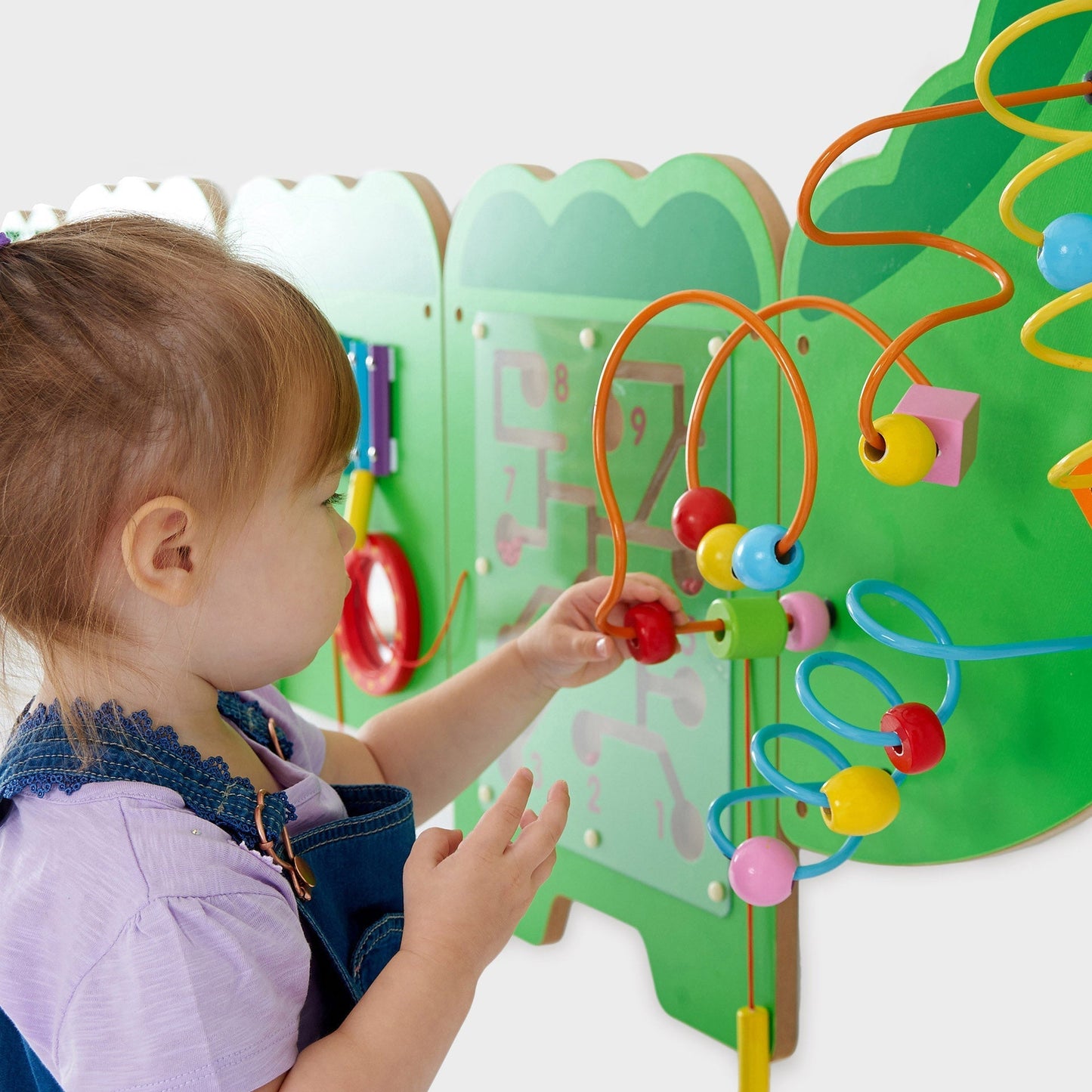 Child playing with a colorful educational beading toy