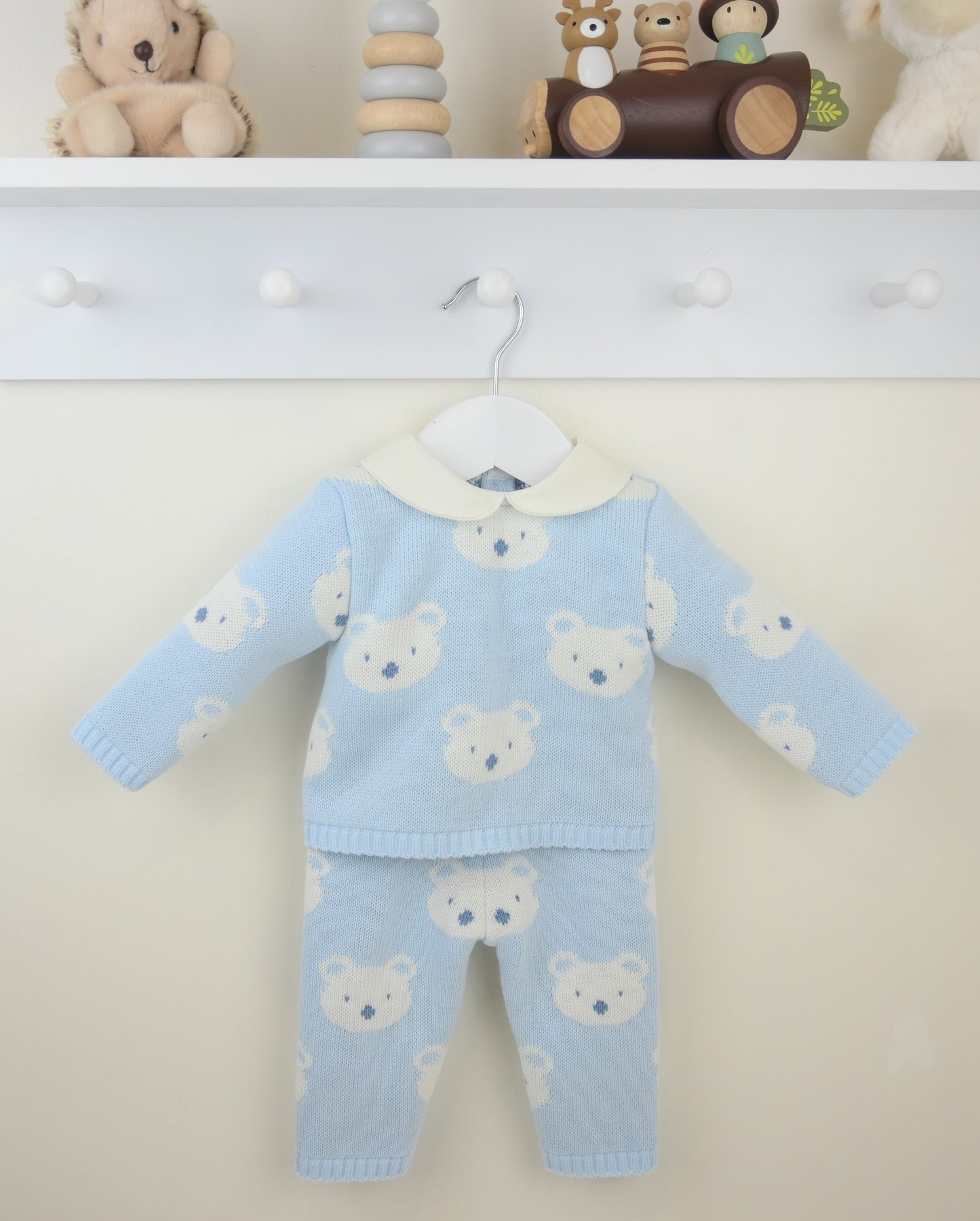 Baby outfit with teddy bear pattern on a white background