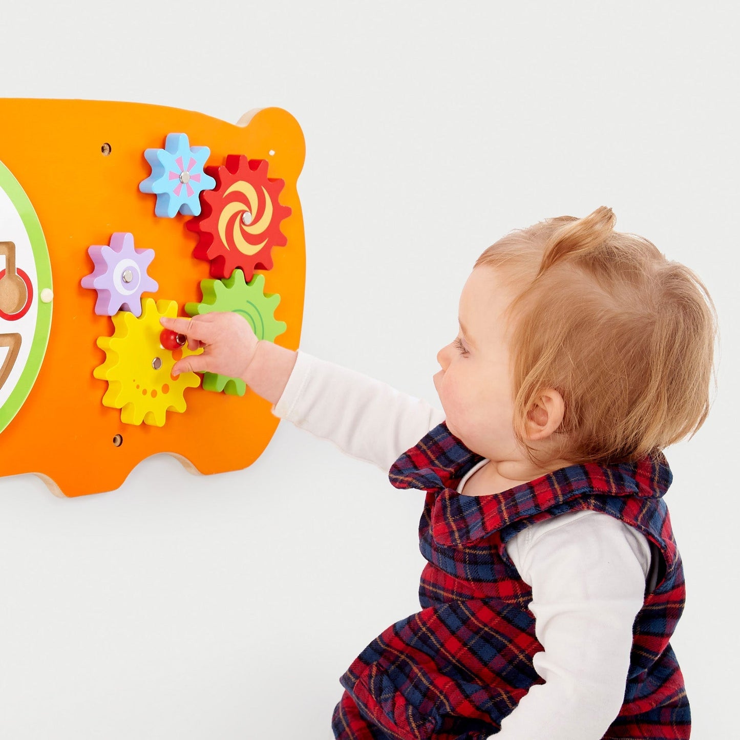 Child playing with a colorful educational toy on a white background