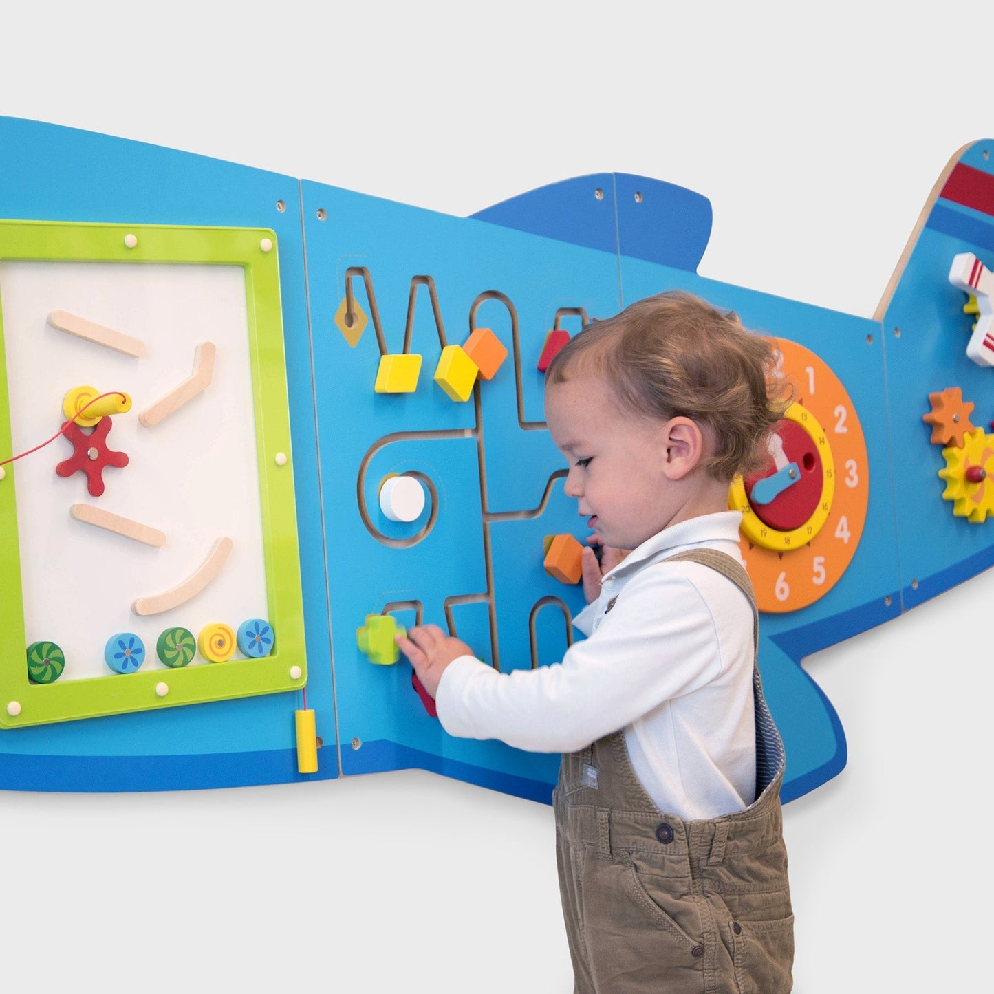 Child interacting with a colorful educational board on a white background