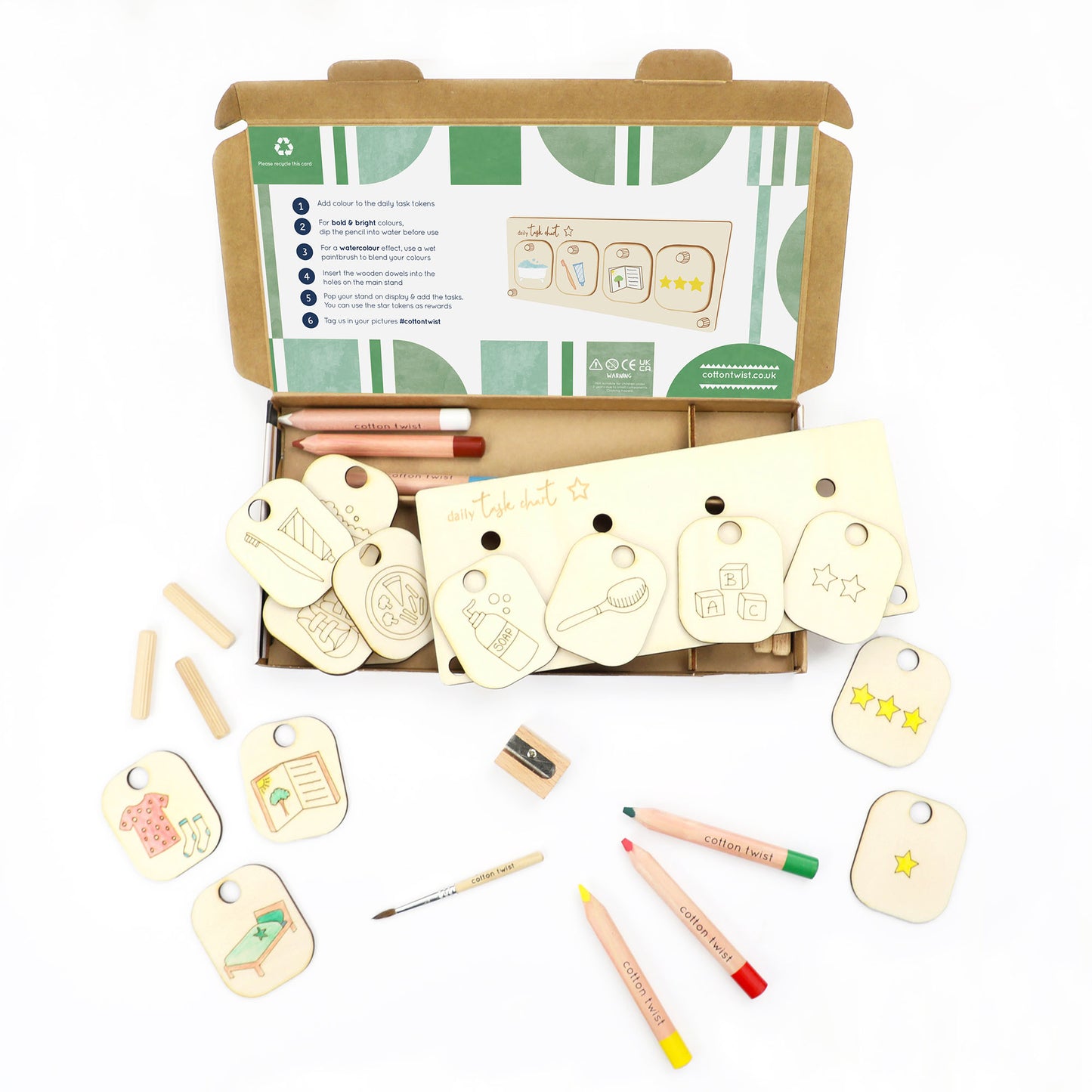 Wooden tags with markers and a box on a white background