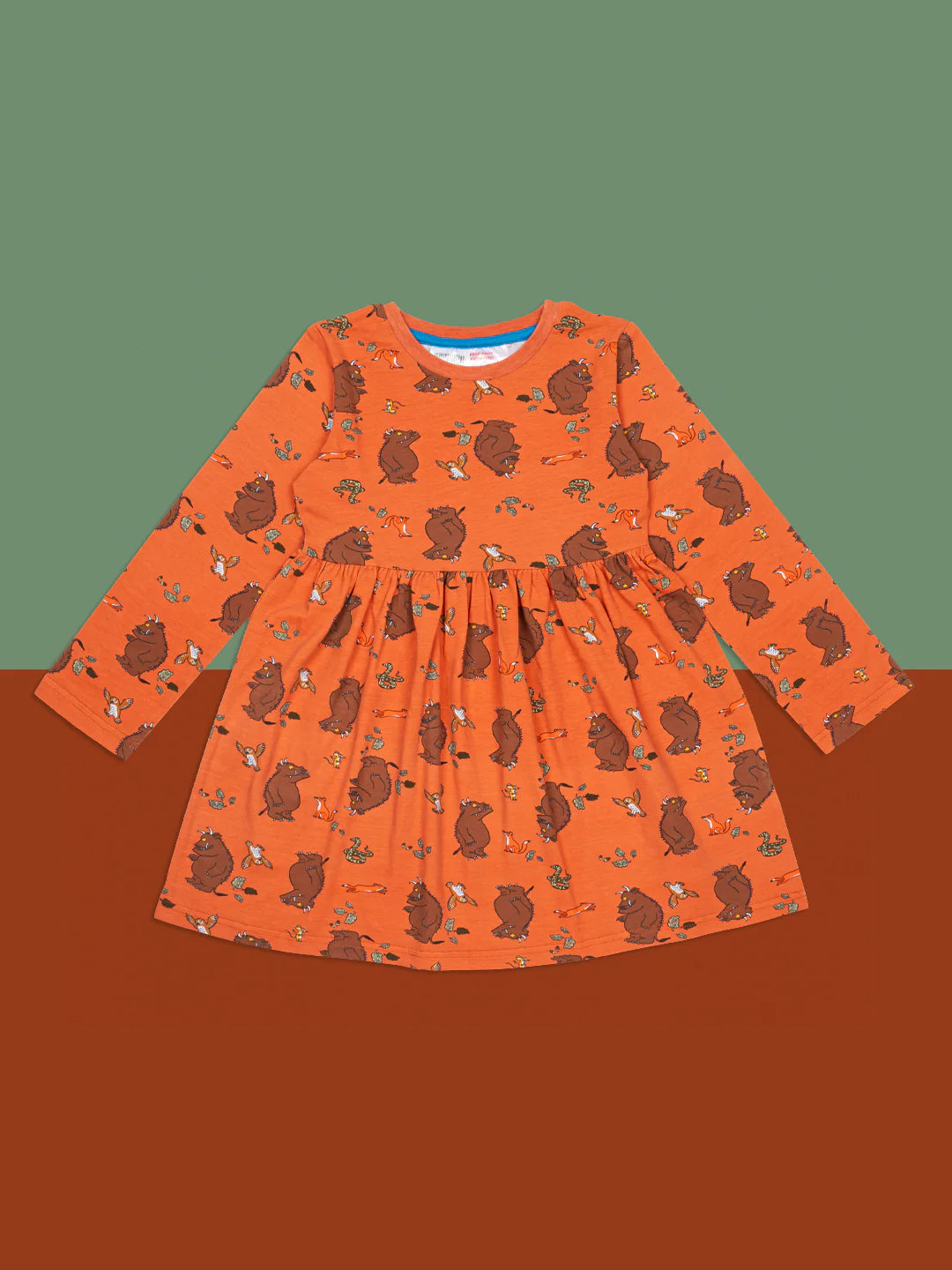 Orange dress with Gruffalo pattern on a brown background
