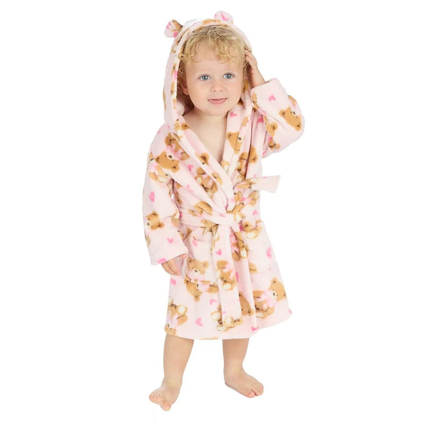 Child wearing a pink teddy bear patterned dressing gown on a white background