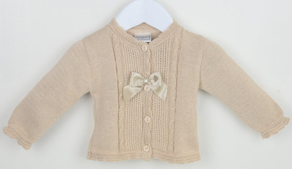 Beige knitted cardigan with a bow on a white background