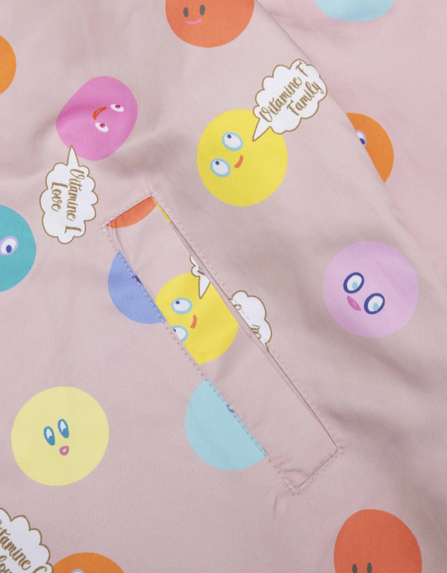 Pink fabric with colorful circle patterns and 'Vitamin Love' branding.