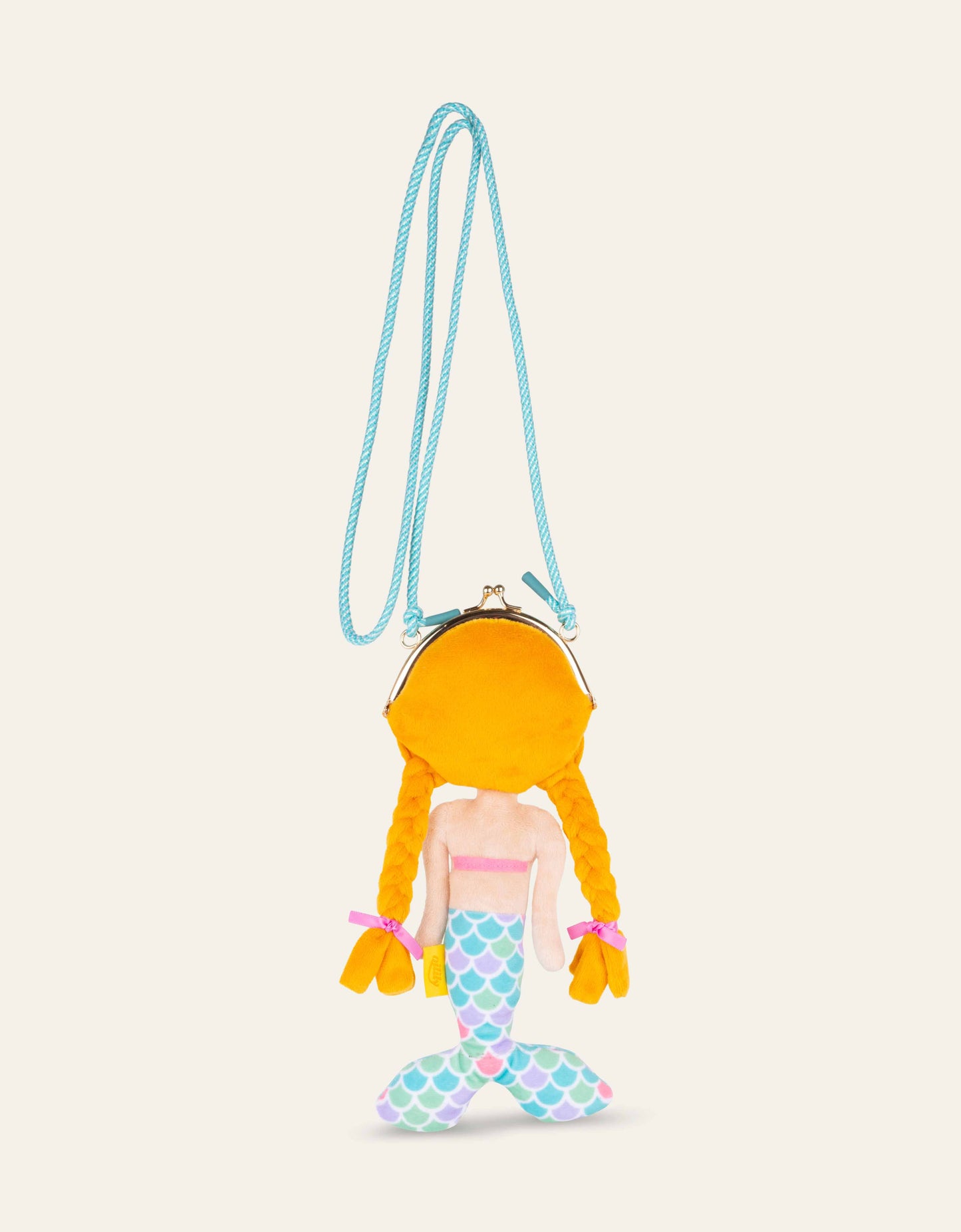 Mermaid-shaped purse with a strap on a beige background