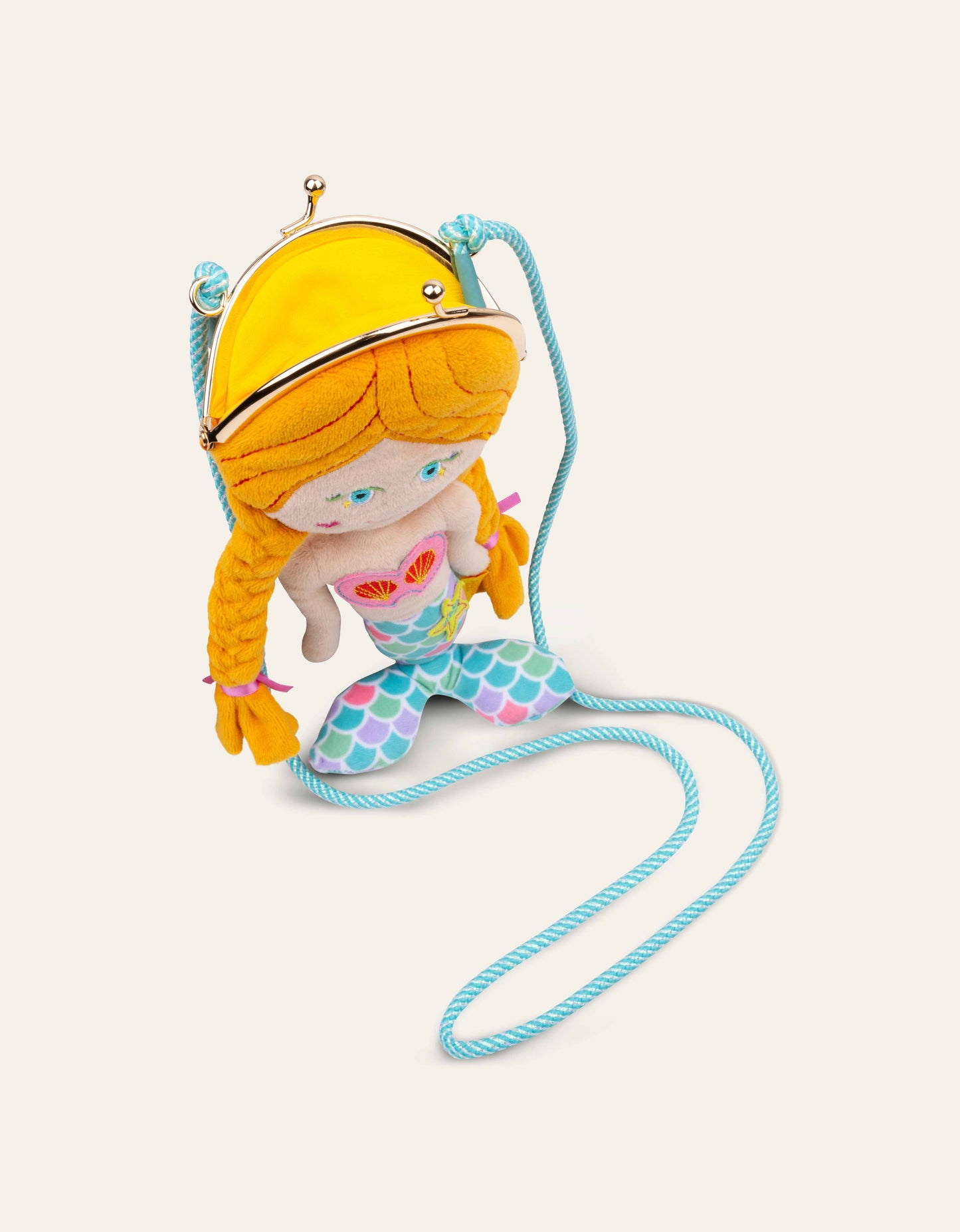 Plush mermaid purse with yellow hair and a blue tail on a white background