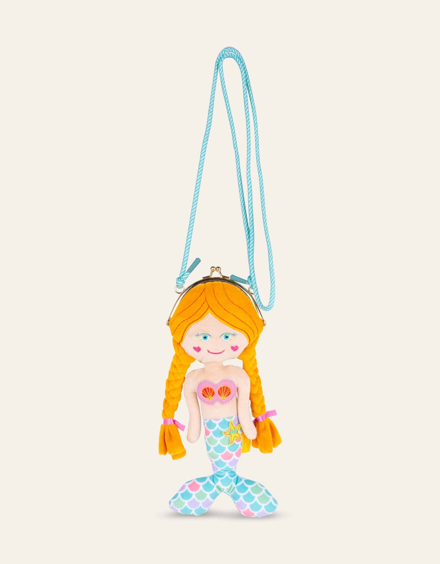 Mermaid-shaped purse with a blue strap on a beige background