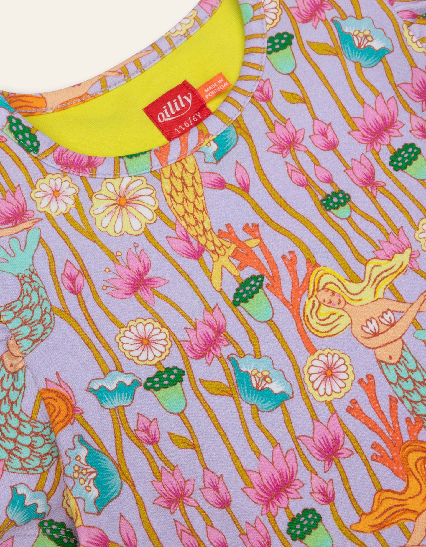 Colorful fabric with mermaid and floral pattern, featuring a visible Oilily brand label.