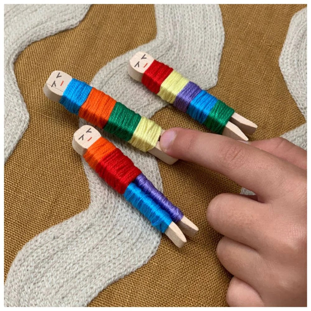 Colorful wooden spools with thread on a textured fabric background