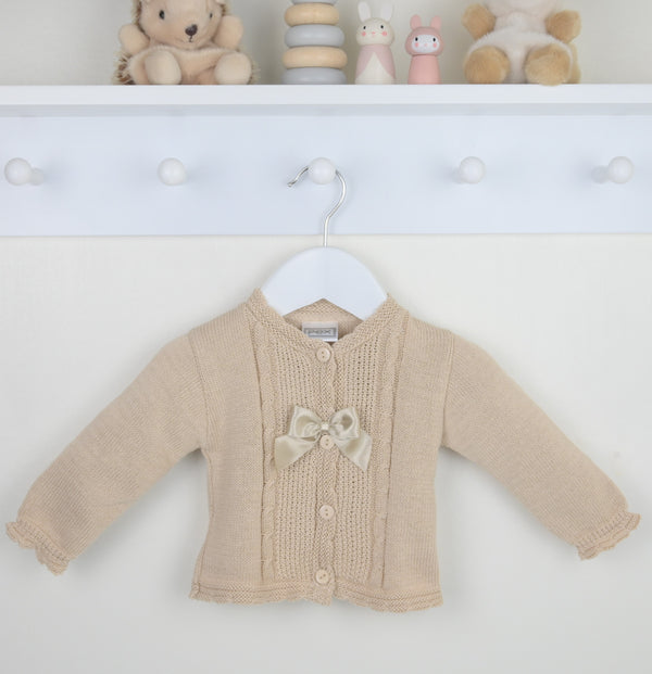 Beige baby cardigan with a bow on a white background