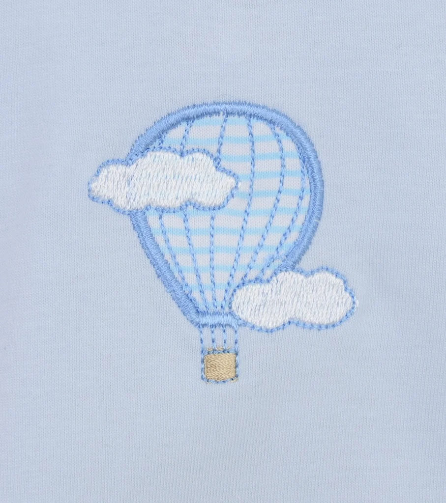 Embroidered design of a hot air balloon with clouds on a light blue fabric background