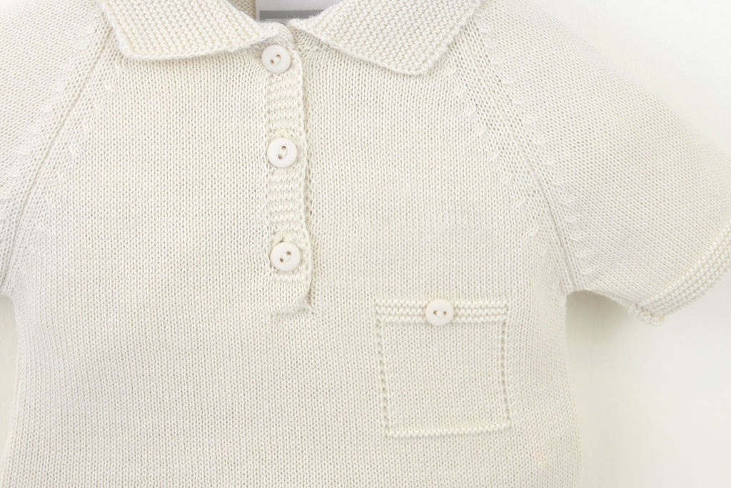 Close-up of a natural knitted polo shirt with buttons on a light background