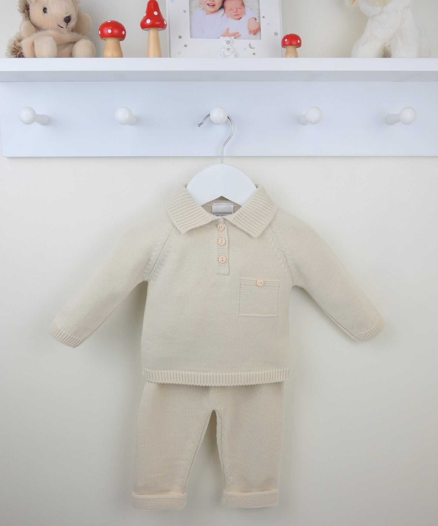 Beige baby outfit with a shirt and pants on a white background