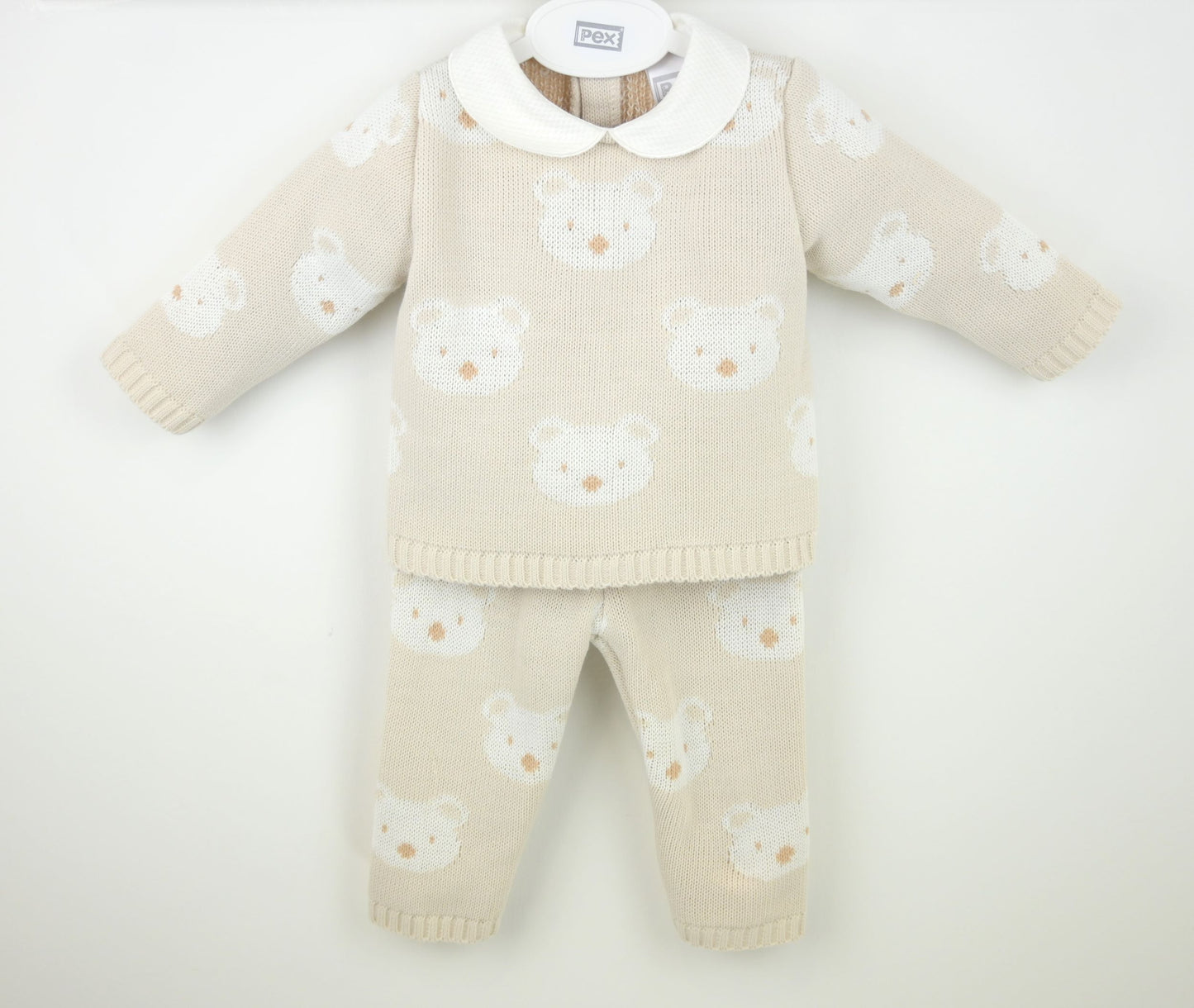 Beige baby sweater and pants set with white bear patterns on a white background