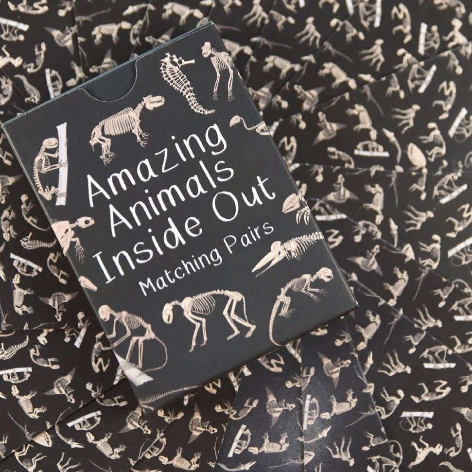Card game packaging with animal skeleton illustrations on a matching background