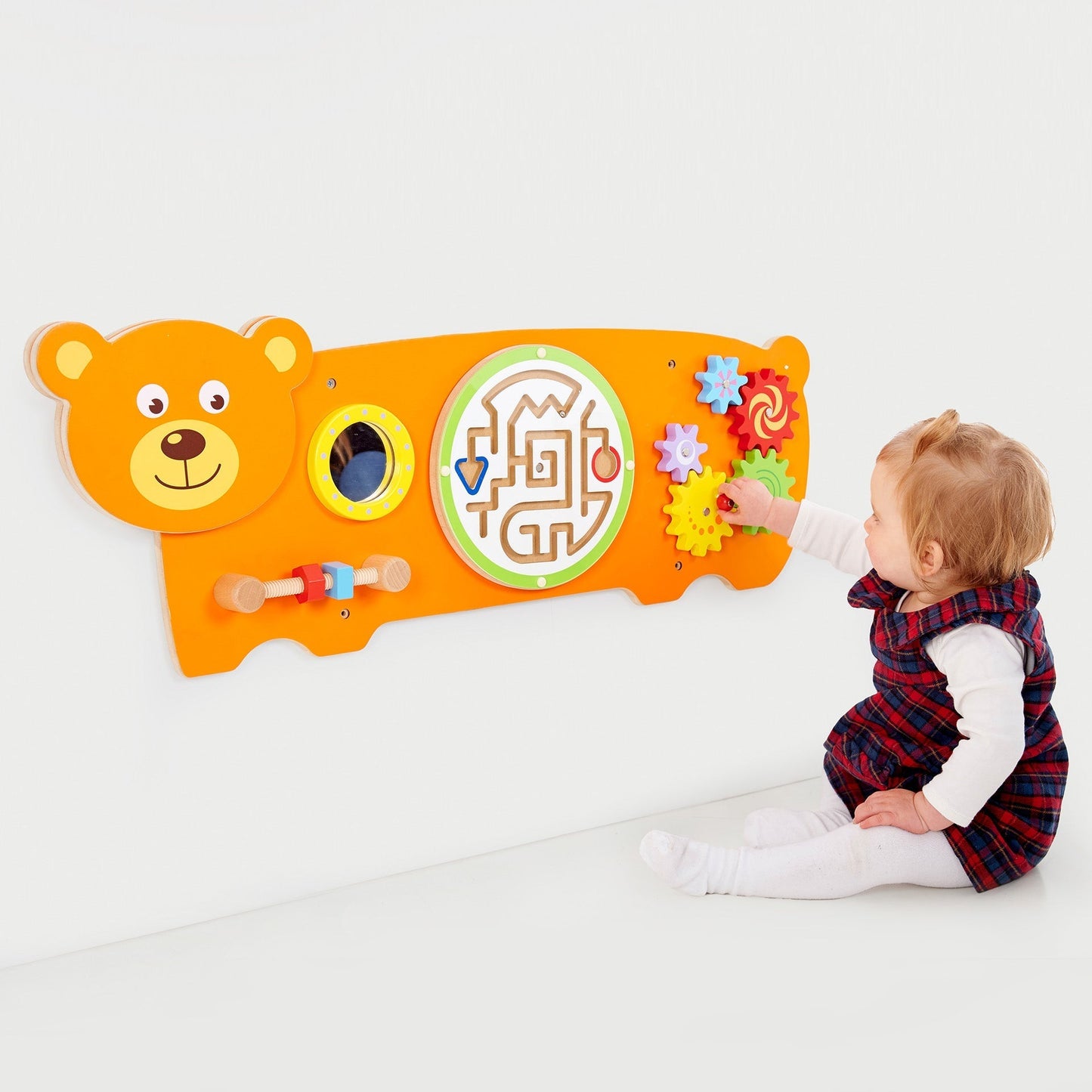 Child playing with a colorful teddy bear-shaped educational toy on a white background