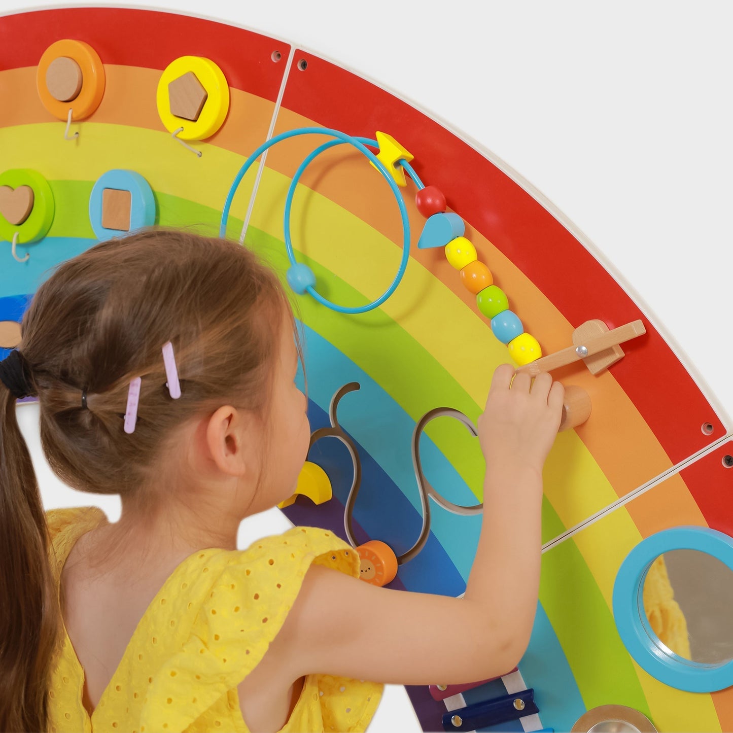 Child playing with a colorful educational toy on a white background