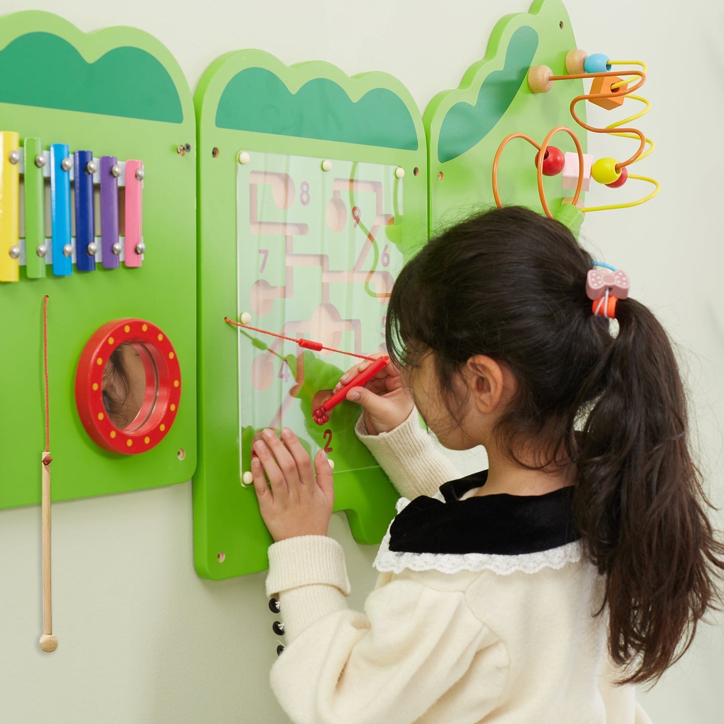 Child interacting with a colorful educational wall panel