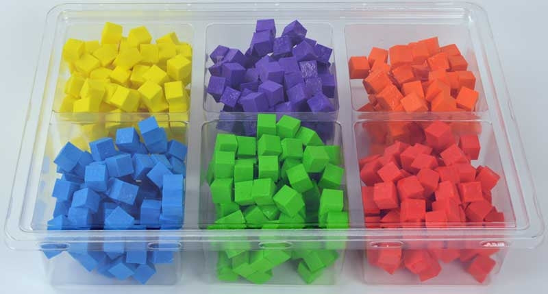 Colorful cube-shaped objects in a clear plastic container on a white background