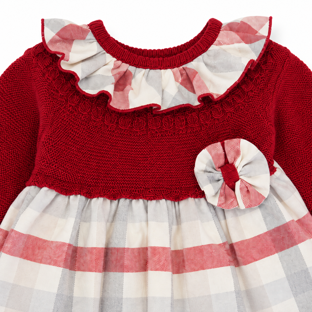 Close-up of Little Nosh red knitted baby dress with tartan frill collar and bow