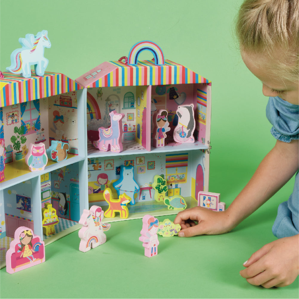 Child playing with fold out toy house