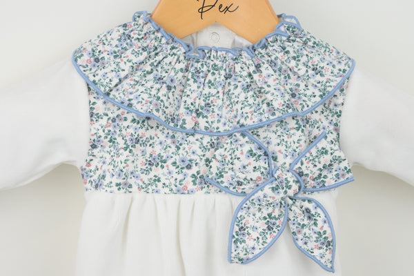 Floral babygrow with bow on a hanger with a white background