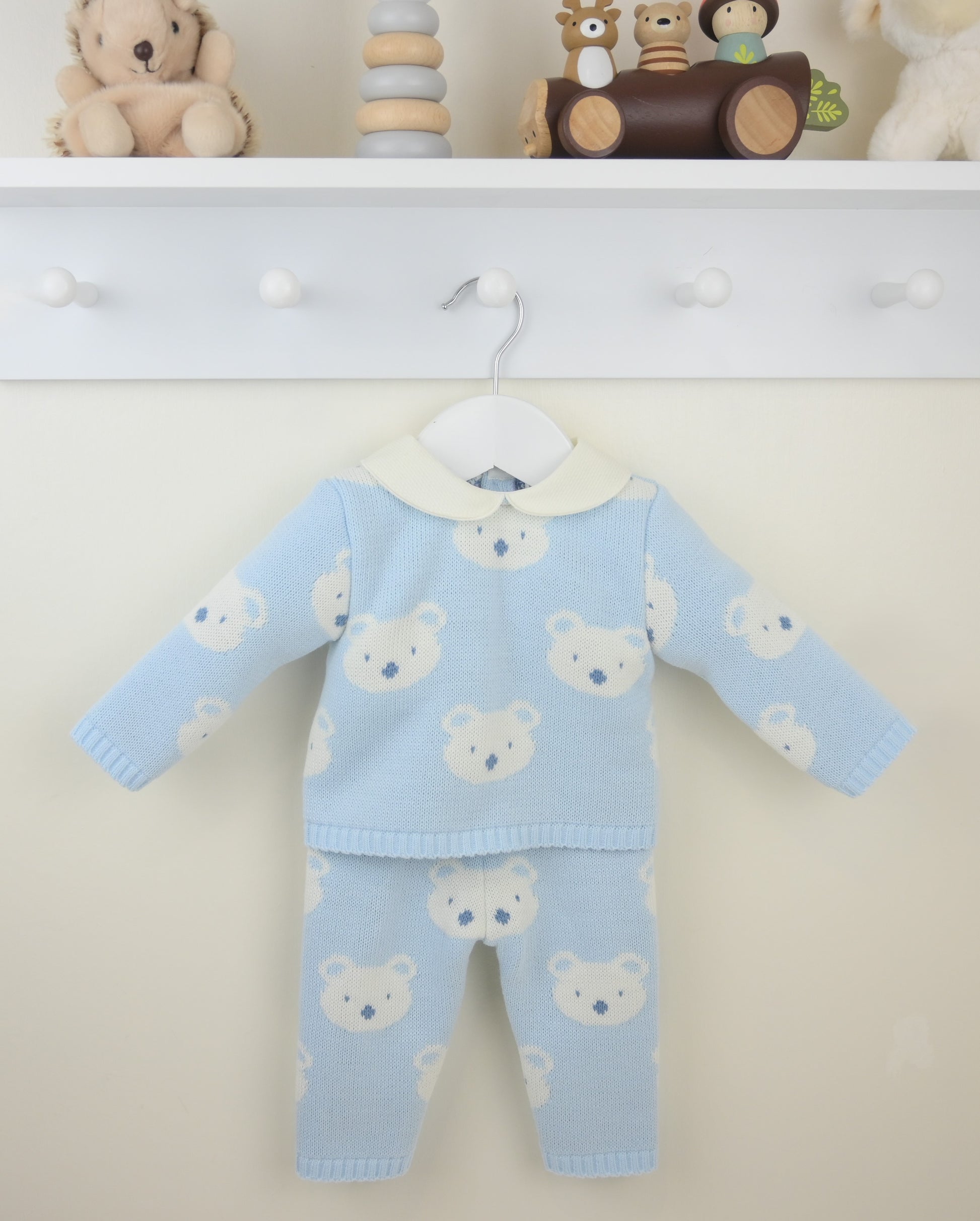 Baby outfit with teddy bear pattern on a white background