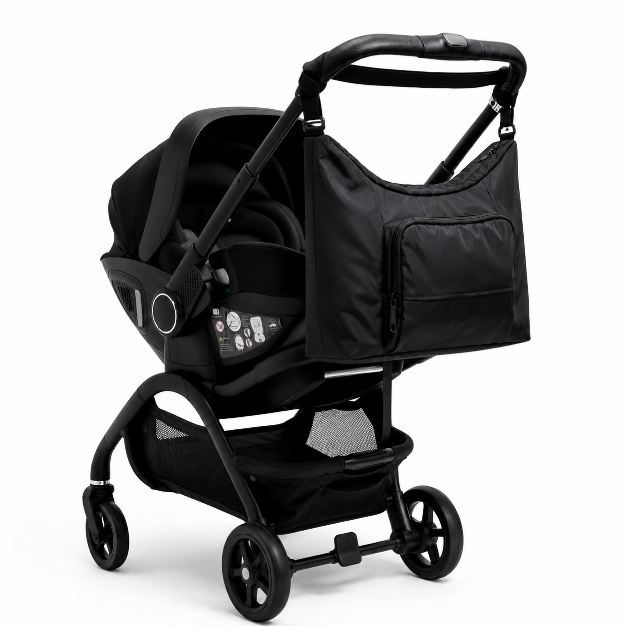 Black Qubi stroller with matching baby chnaging bag attached to handle.