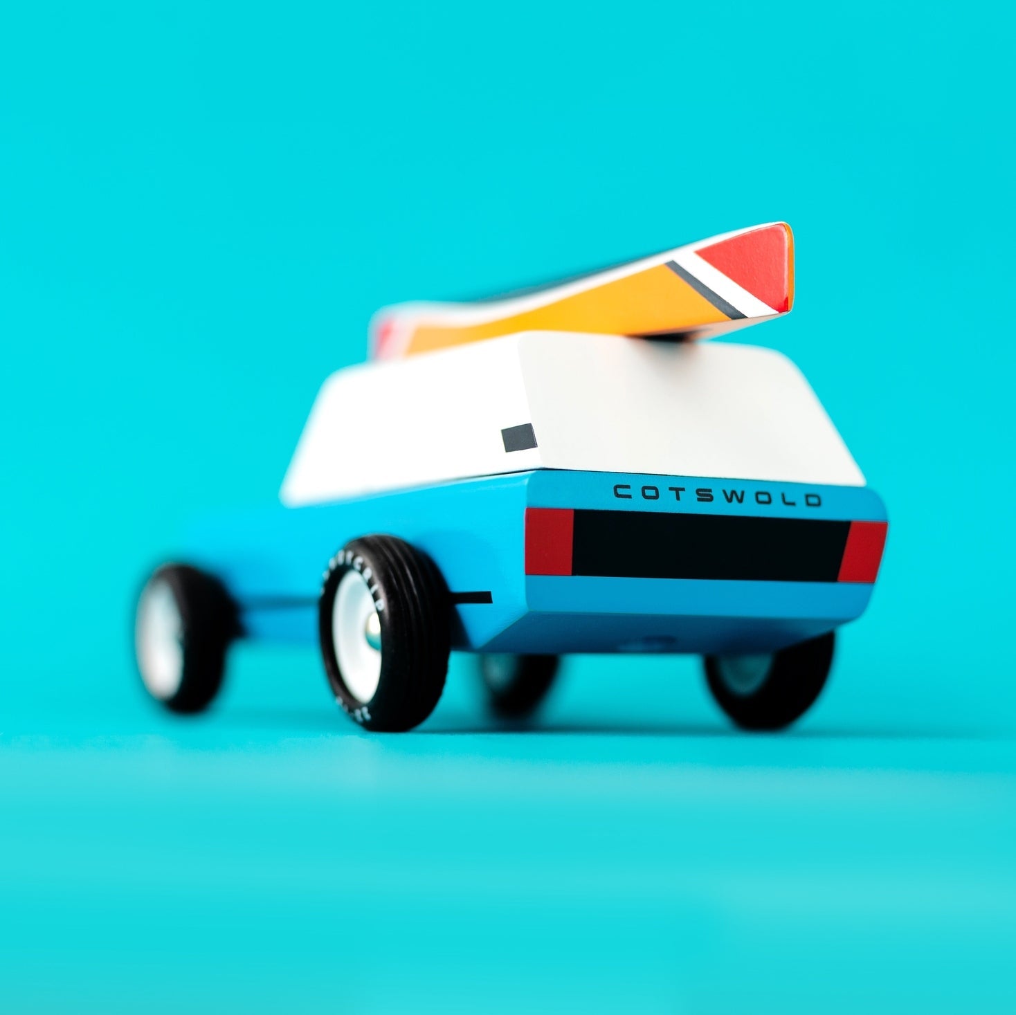 Toy car with 'Cotswold' branding on a blue background