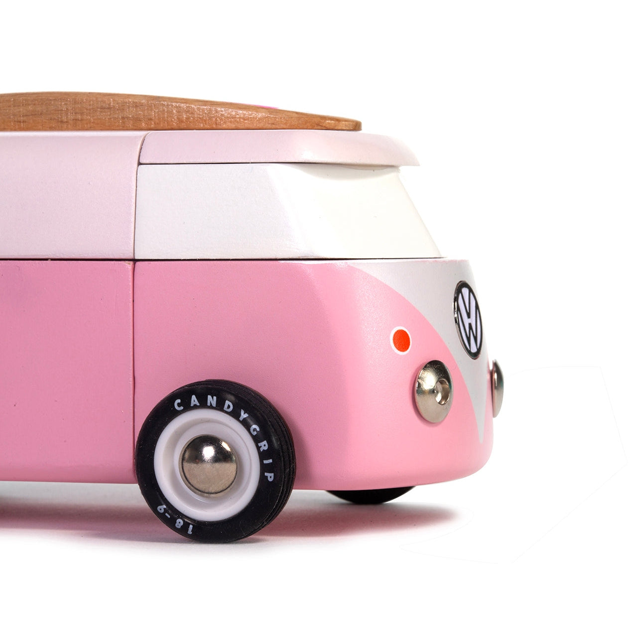 Pink Volkswagen beach bus toy on a white background