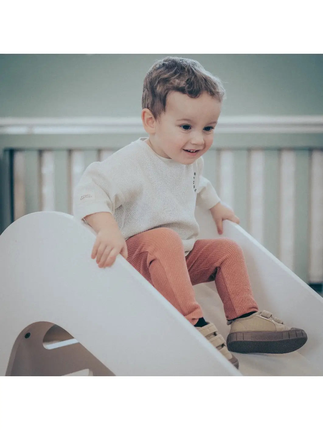 Child wearing rust organic cotton waffle leggings