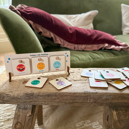 Wooden Feelings Chart on a wooden table with pillows in the background