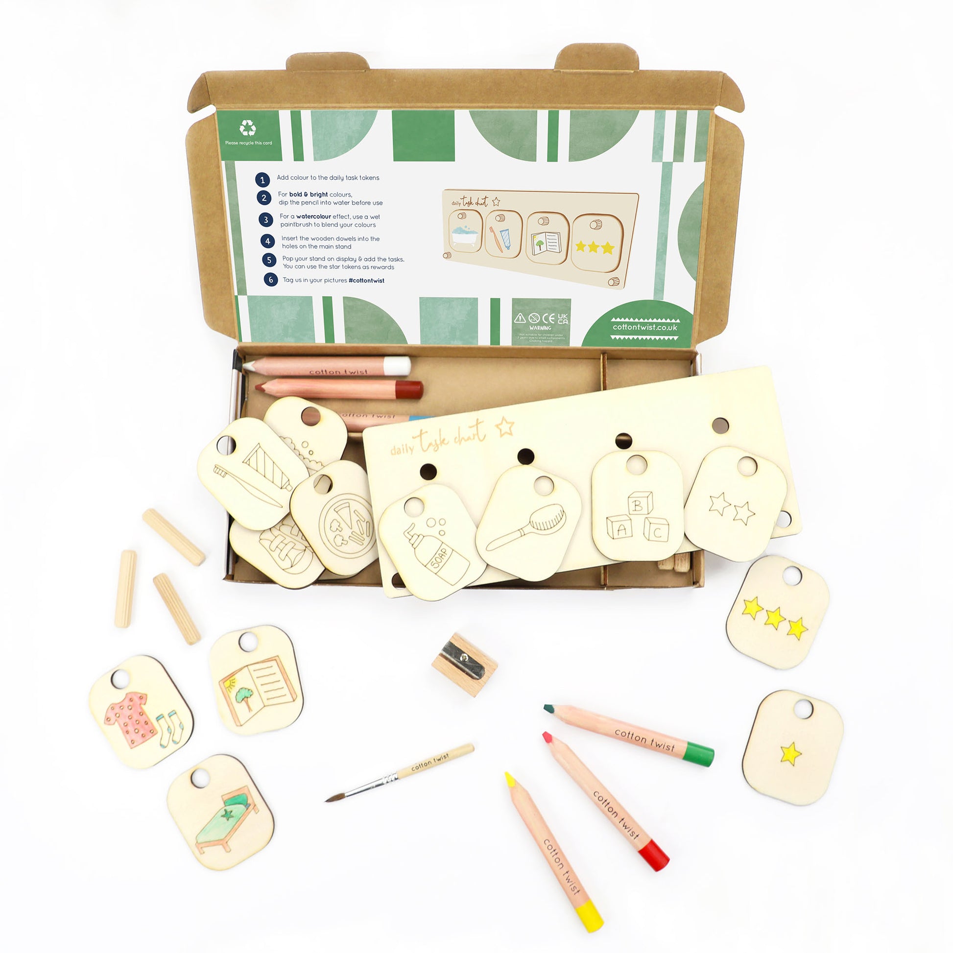 Wooden tags with markers and a box on a white background