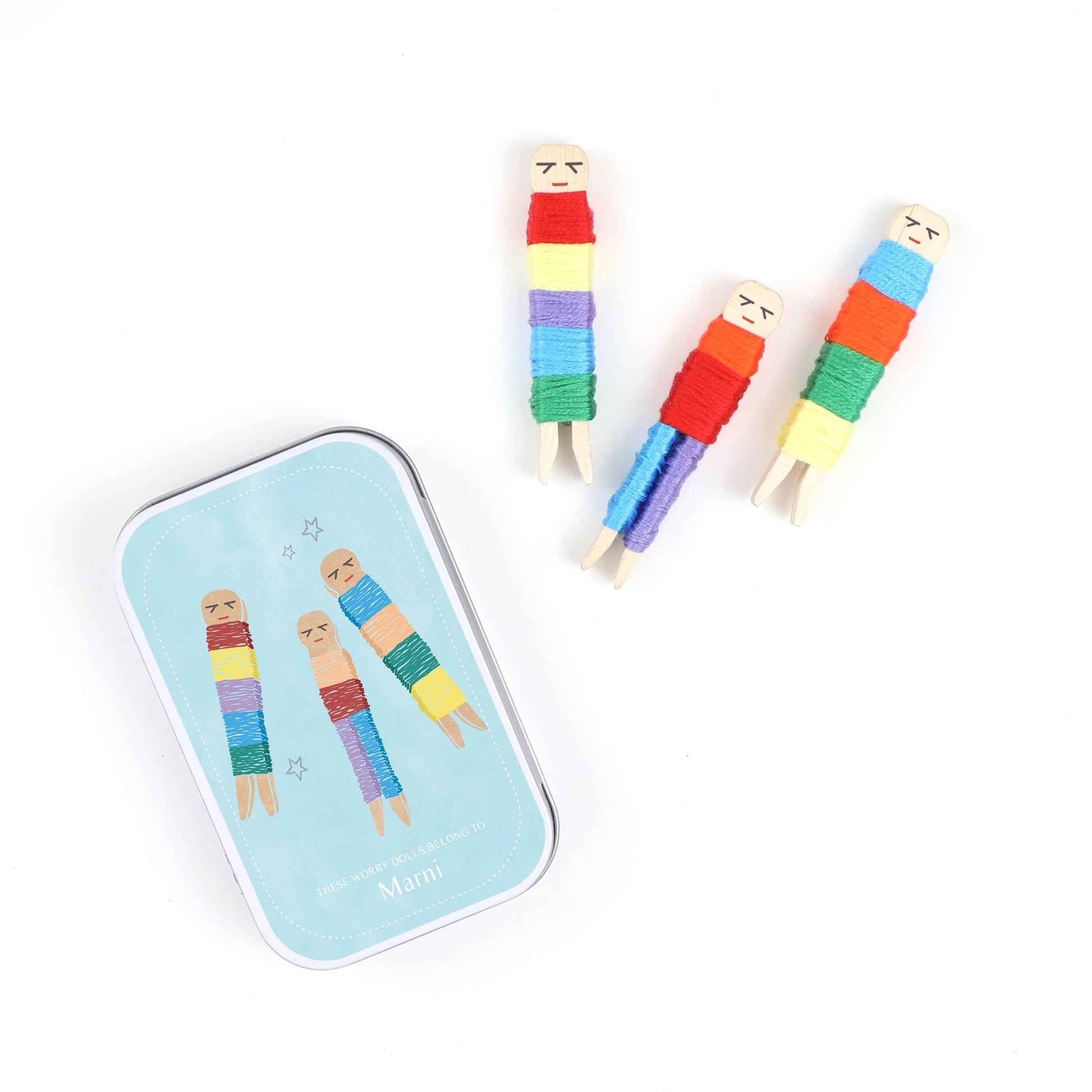 Colorful striped worry dolls on a white background with a branded tin.