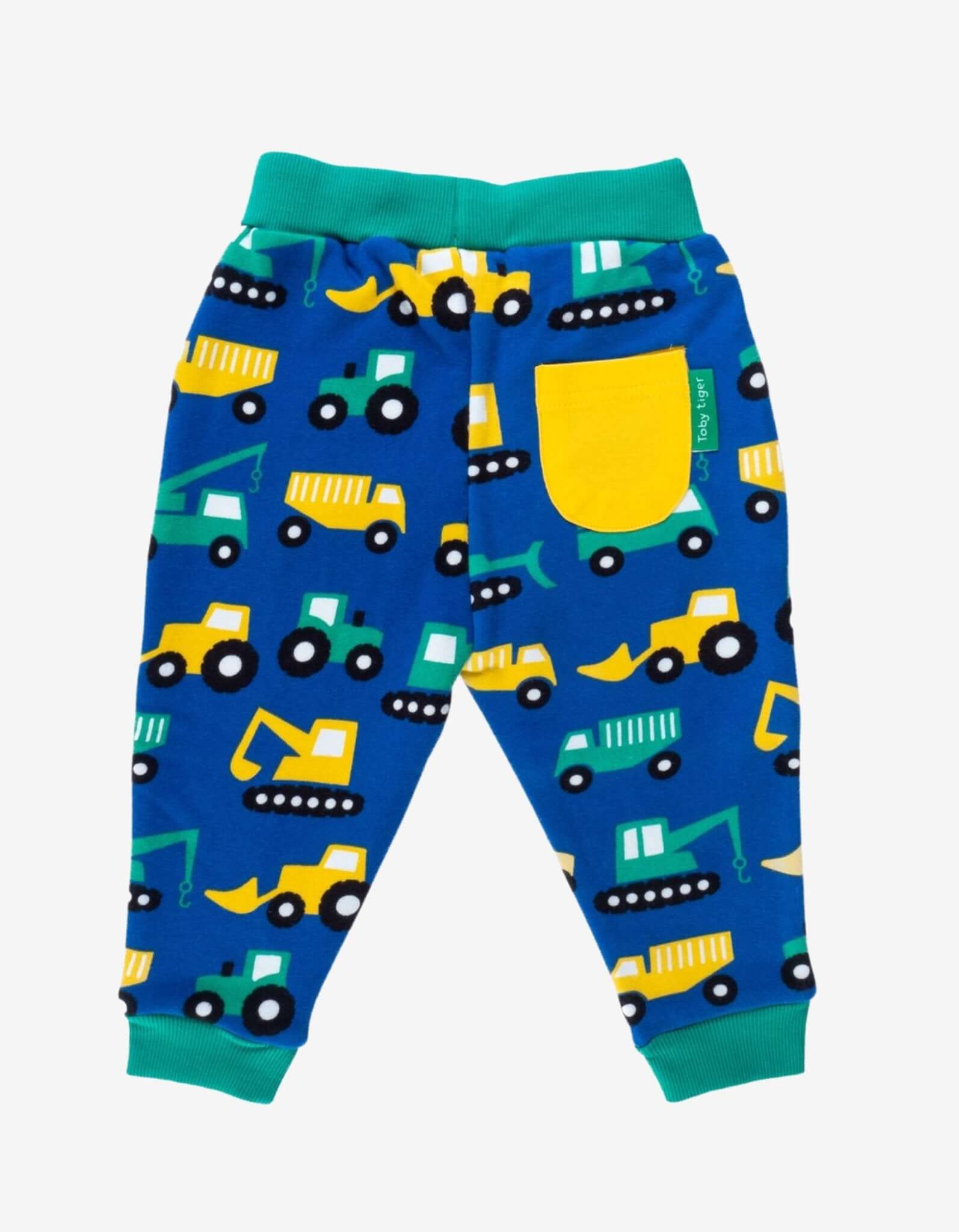 Blue children's bottoms with construction vehicle pattern on a white background