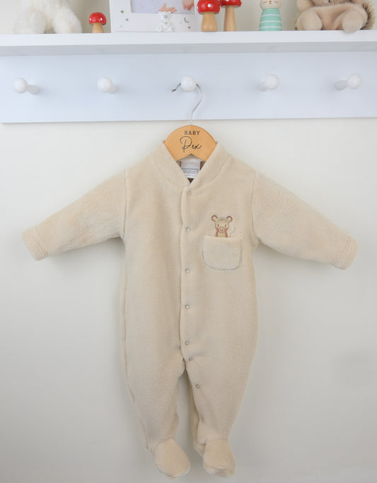 Beige baby onesie with a mouse design on a white wall