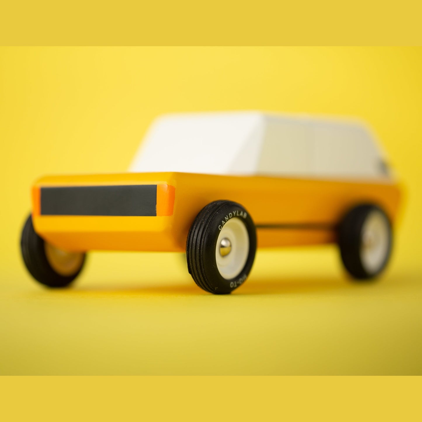 Toy car model on a yellow background