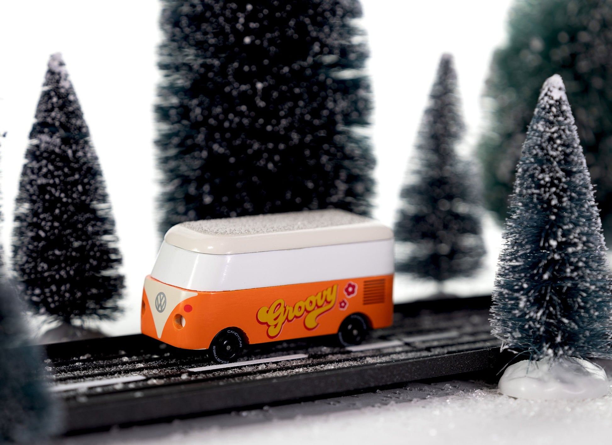 Model toy on a track with snow-covered trees in the background