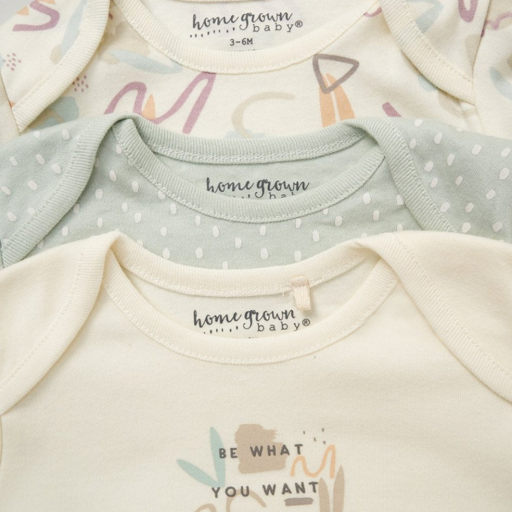 Close-up of baby onesies with 'home grown baby' branding on a white background