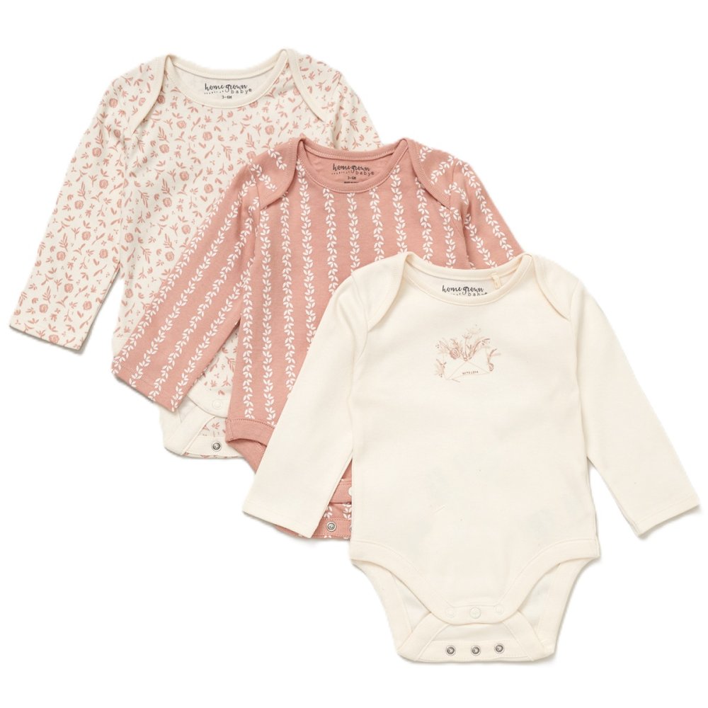 Three baby bodysuits with floral and patterned designs on a white background