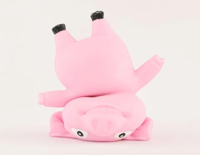 Stretchy and squishy Keycraft pig toy stood upside down.
