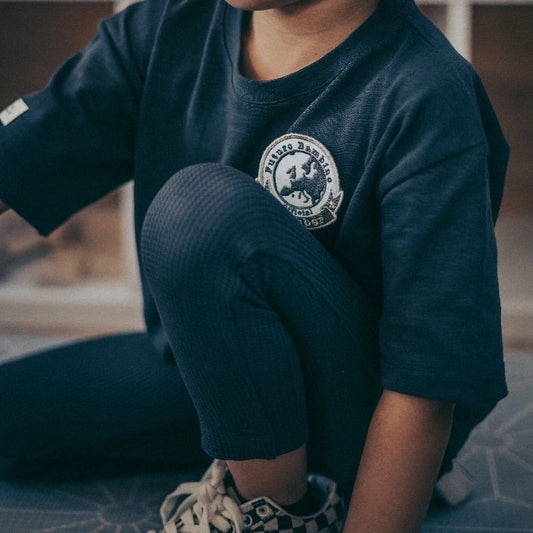 Child wearing charcoal organic cotton waffle leggings