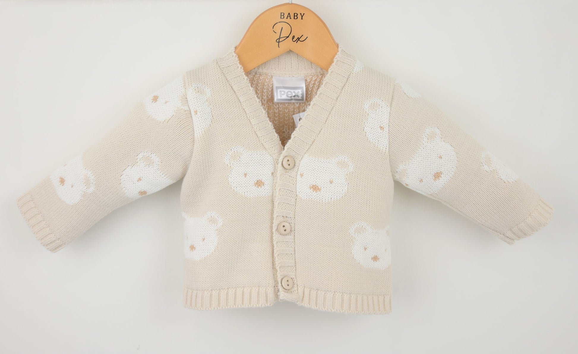 Baby cardigan with bear pattern on a white background