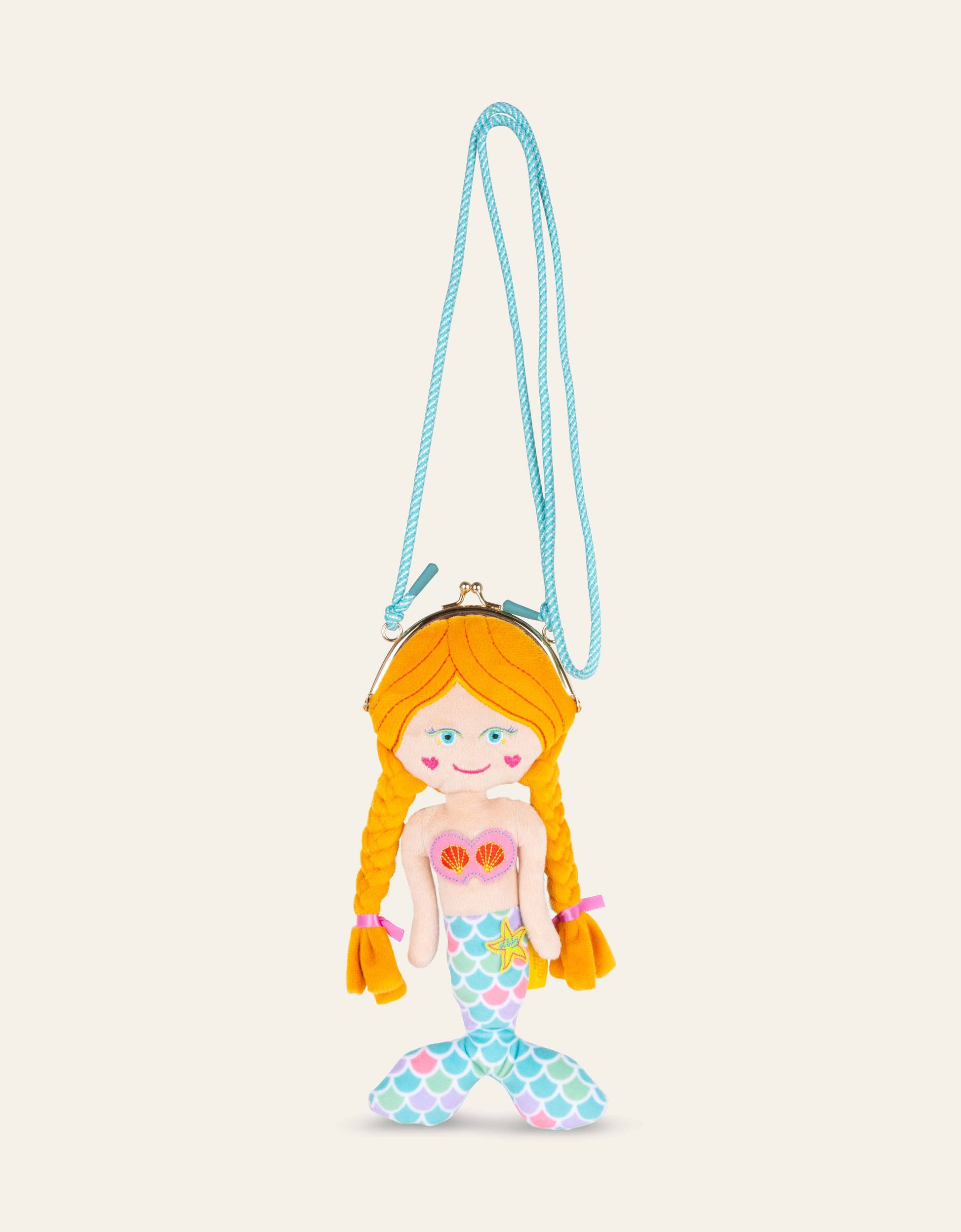 Mermaid-shaped purse with a blue strap on a beige background