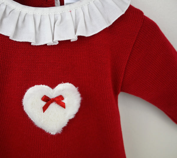 Red sweater dress with a white heart and red bow detail on a plain background