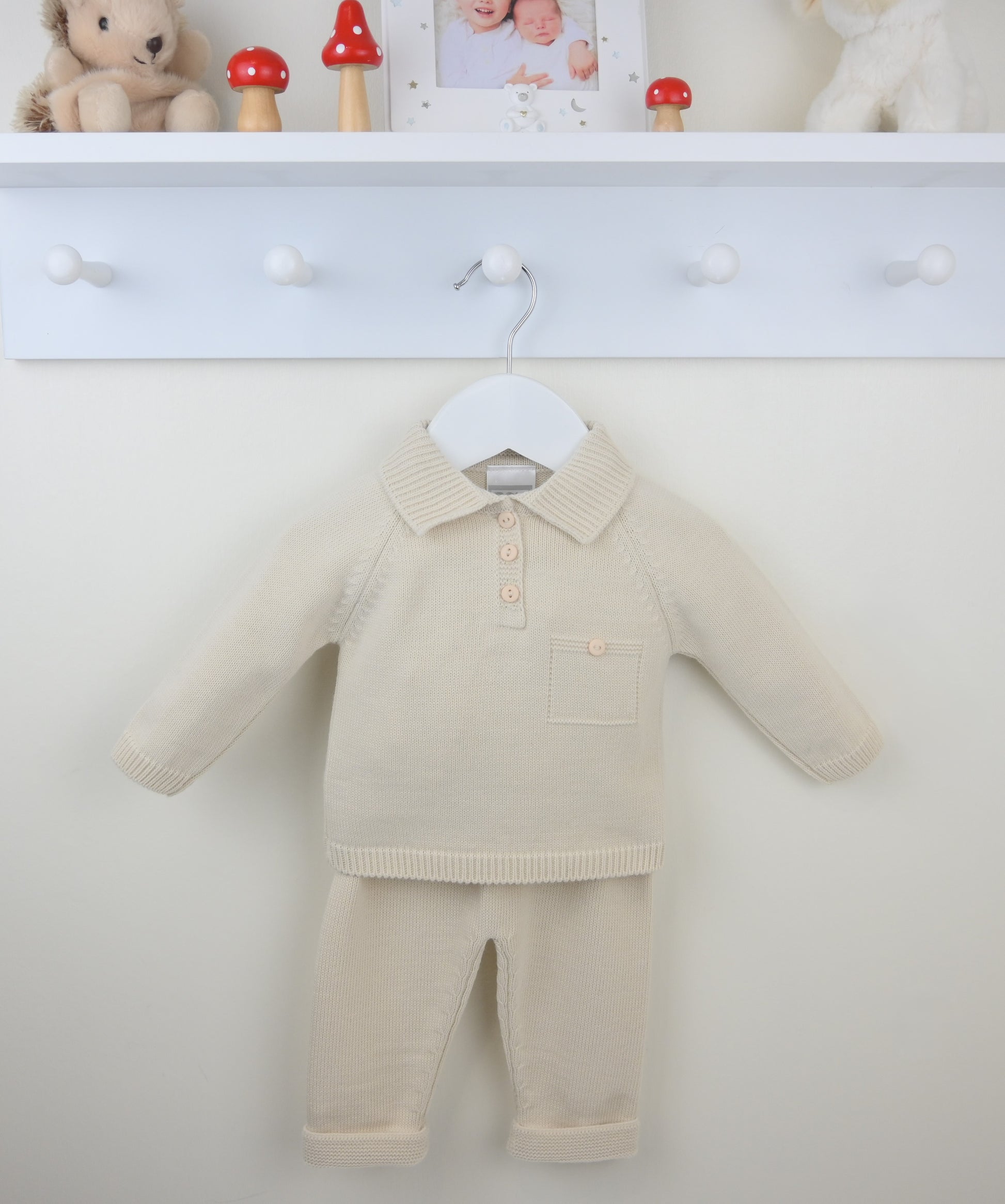 Beige baby outfit with a shirt and pants on a white background