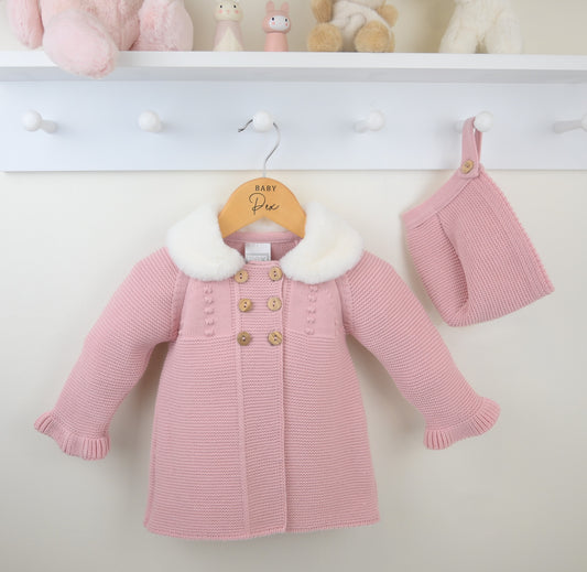Pink baby coat with white fur trim and matching hat on a hanger against a white background.