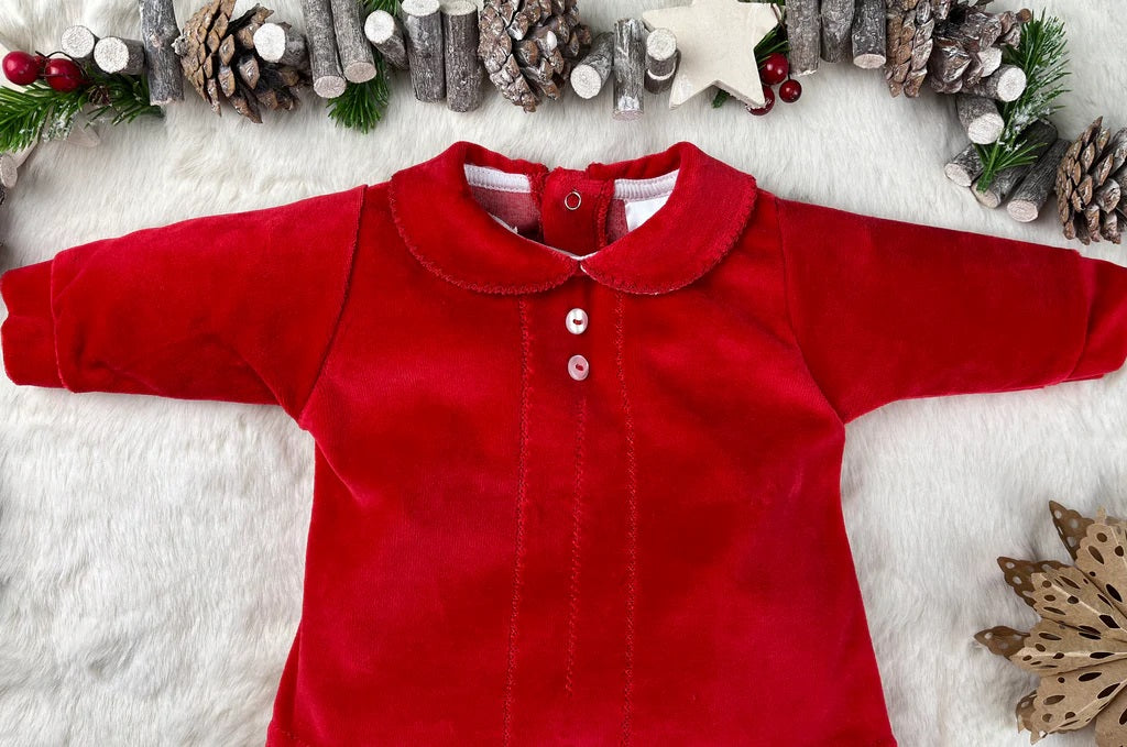 Red baby outfit with Christmas decorations on a white background