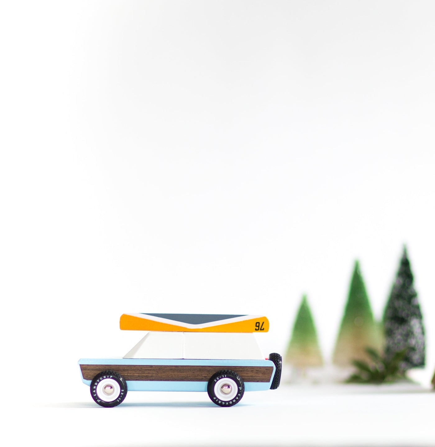 Toy wooden car with trailer on a white background